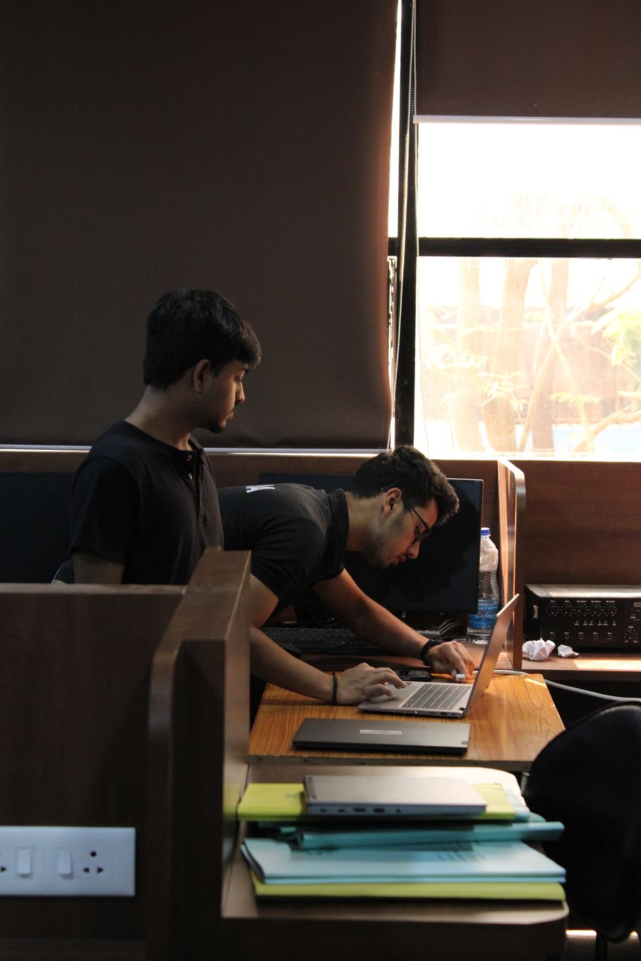 Aaron working on a laptop at a desk, another lab member alongside