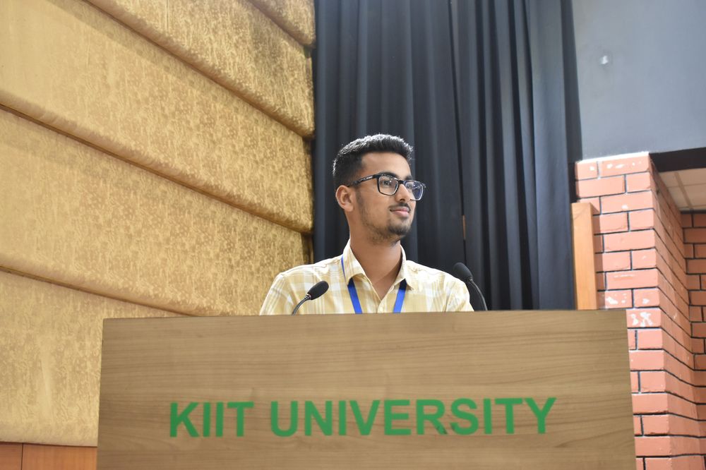 Aaron speaking at a KIIT University podium